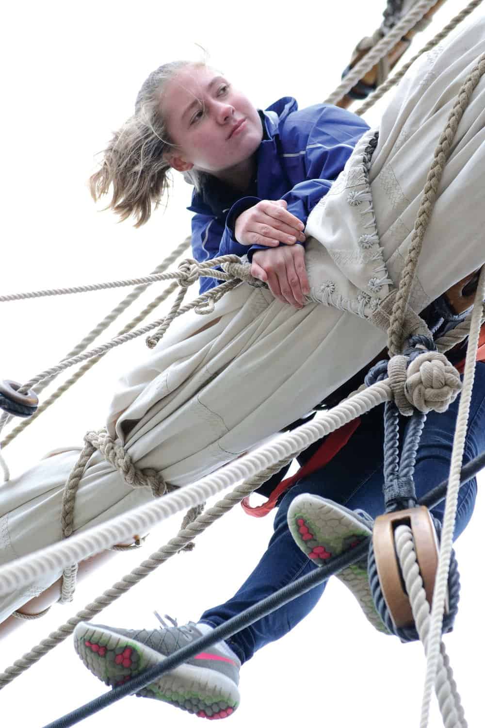   Anna Hower tends to the sails aloft.- Photos by K aren Soule 