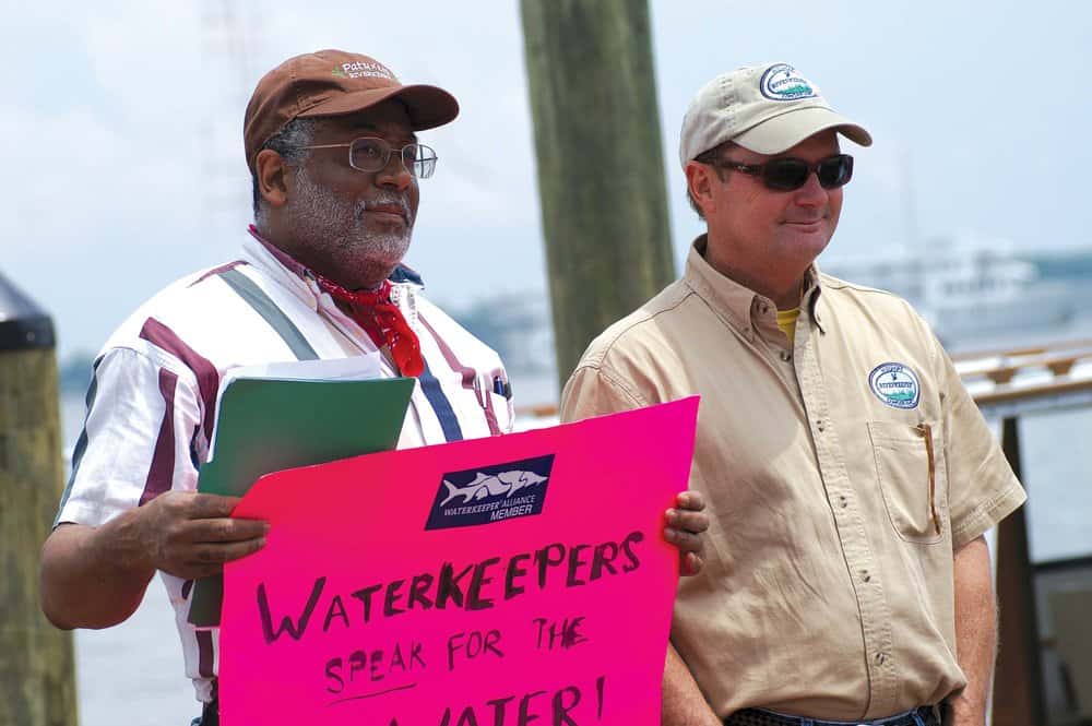  Tutman, protest sign in hand, stands with fellow riverkeepers  protesting the lack of  progress in at the Annapolis City Dock event is Tim Junkin, of the Midshore Riverkeeper Conservancy. Courtesy of Fred Tutman.  