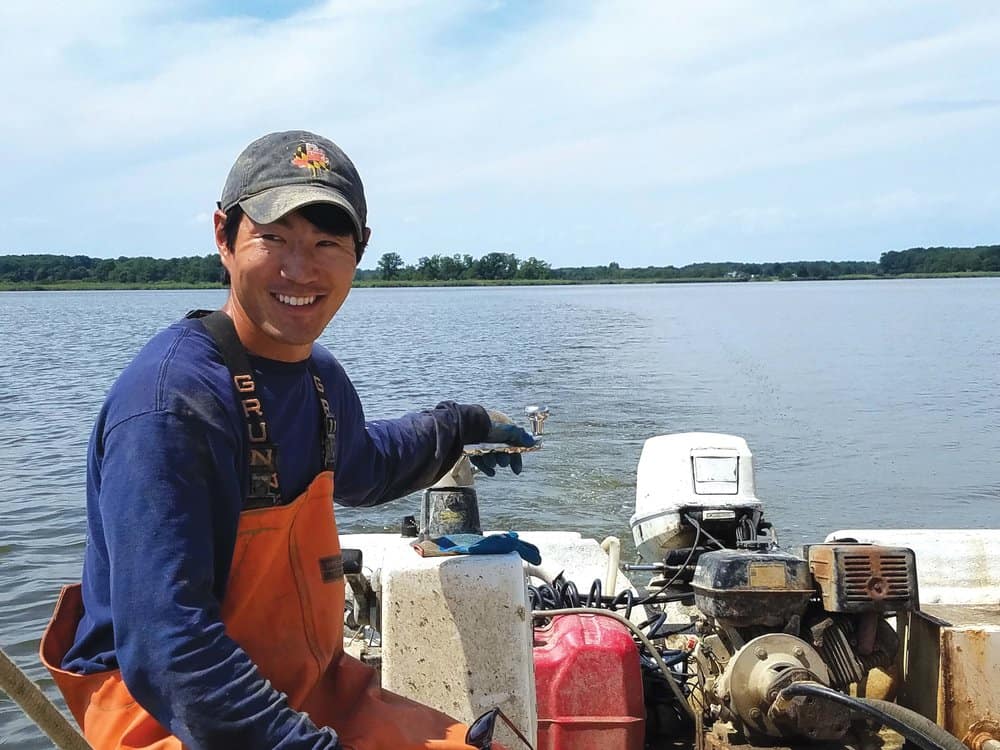  Scott Budden and mate Sean Corcoran on the Chester River, working Budden’s oyster lease. Photo by Laura Boycourt. 