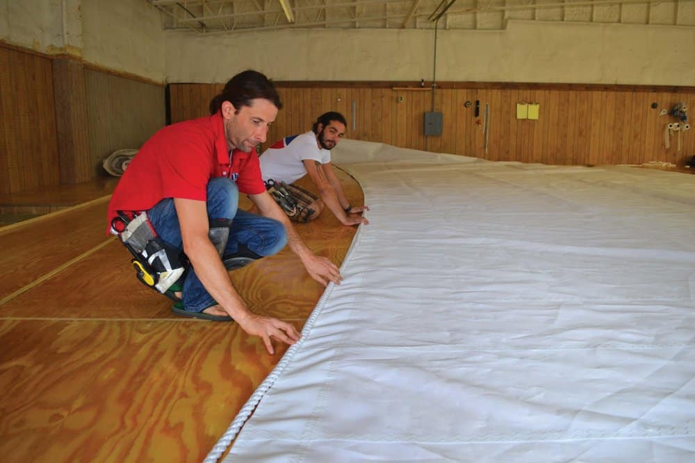  Sailmakers Ailsworth and Jake Pender lay out a sail’s bolt-rope. Photo by Karen Soule. 
