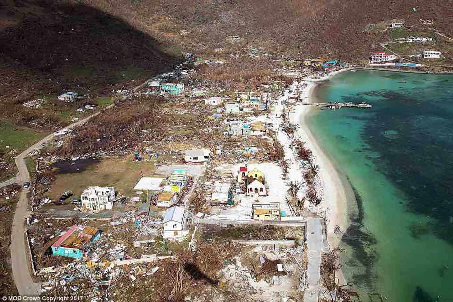  In this photo of the Jost Van Dyke beachfront just after Irma, Foxy’s Tamarind Bar is at the far end, covered with blue tarps. 